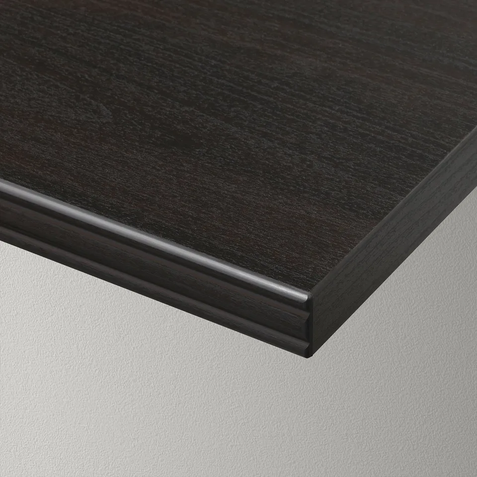 Black rectangular wall shelf with a bevelled edge, resting on a white surface. The finish is smooth and seamless.