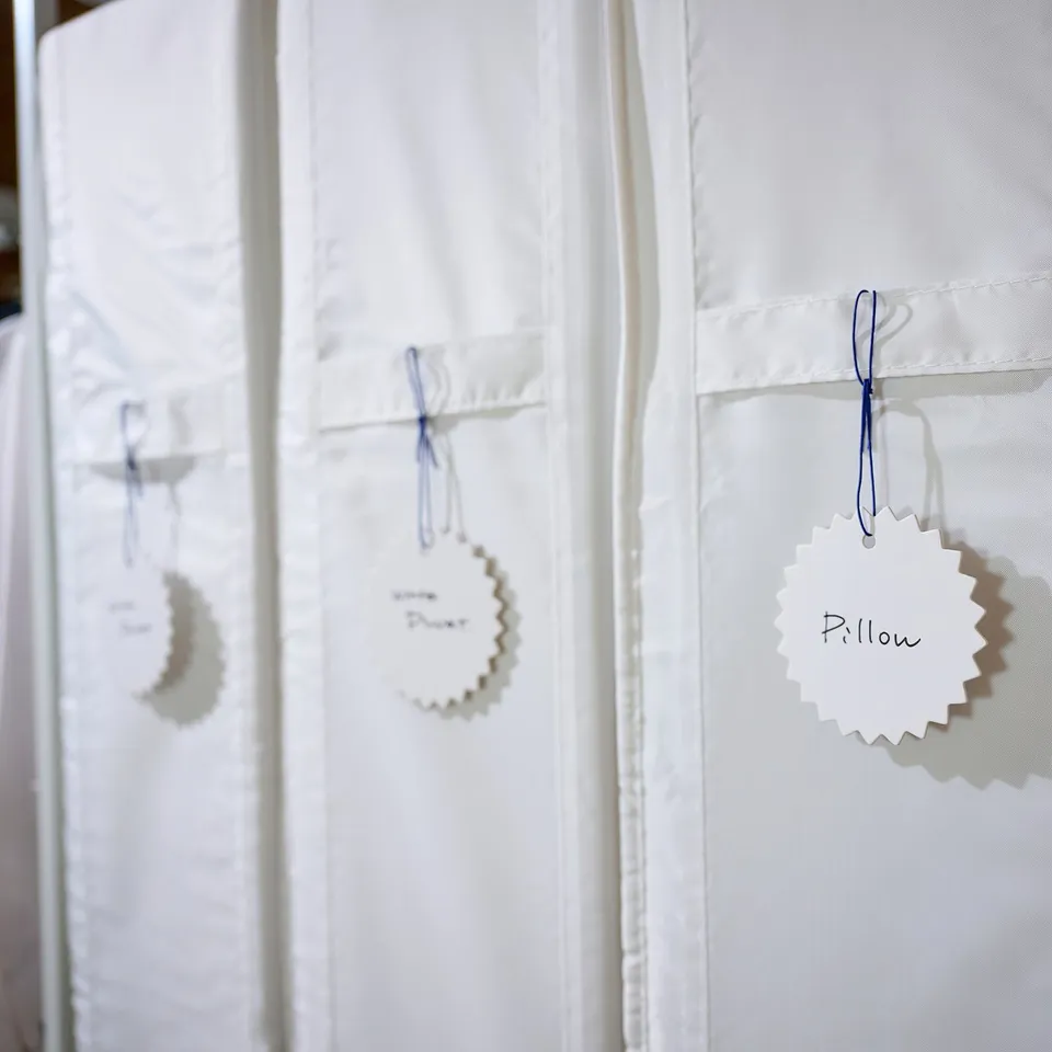 SKUBB cases hang with tags and blue strings for dust-free bedding