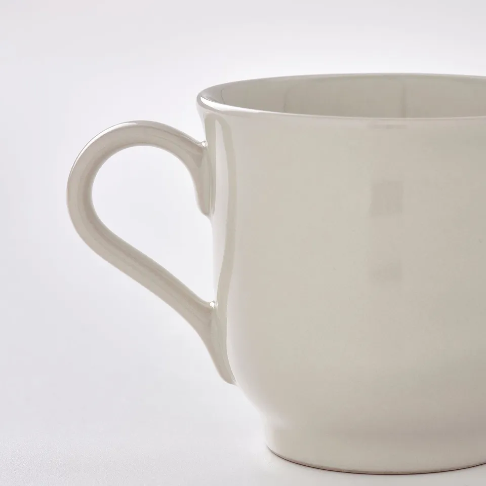 White glazed mug with curved handle.