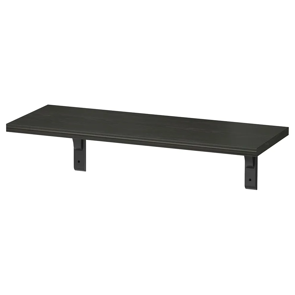 The black BERGSHULT wall shelf with a bevelled and smooth edge, supported by dark brackets.