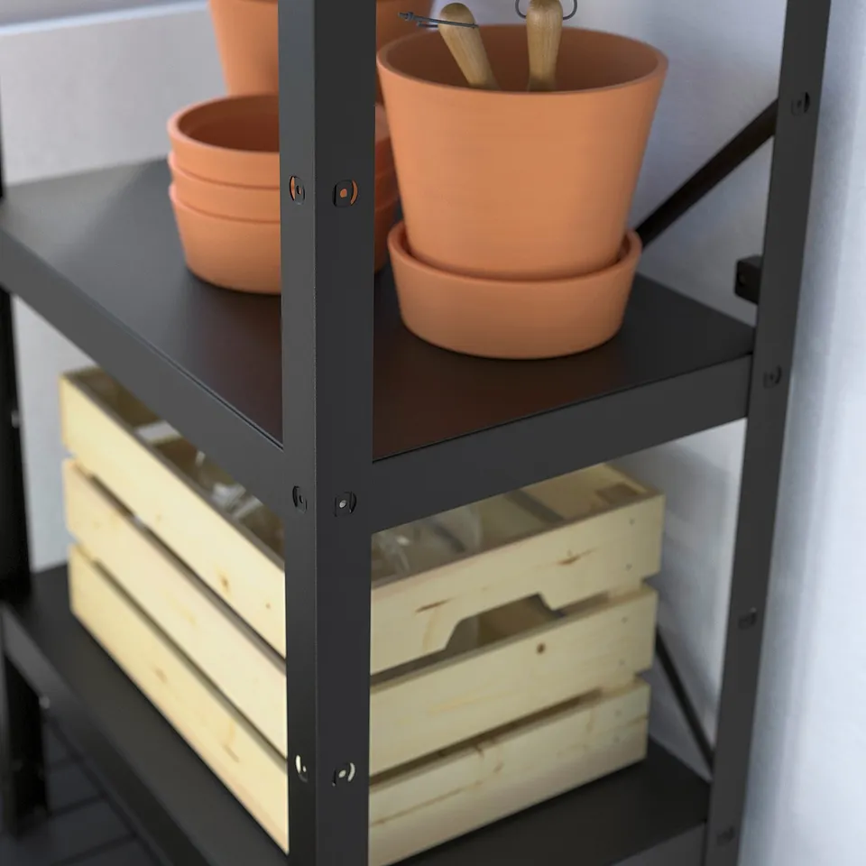 Shelf displaying terracotta pots, wooden crates, and metal brackets.