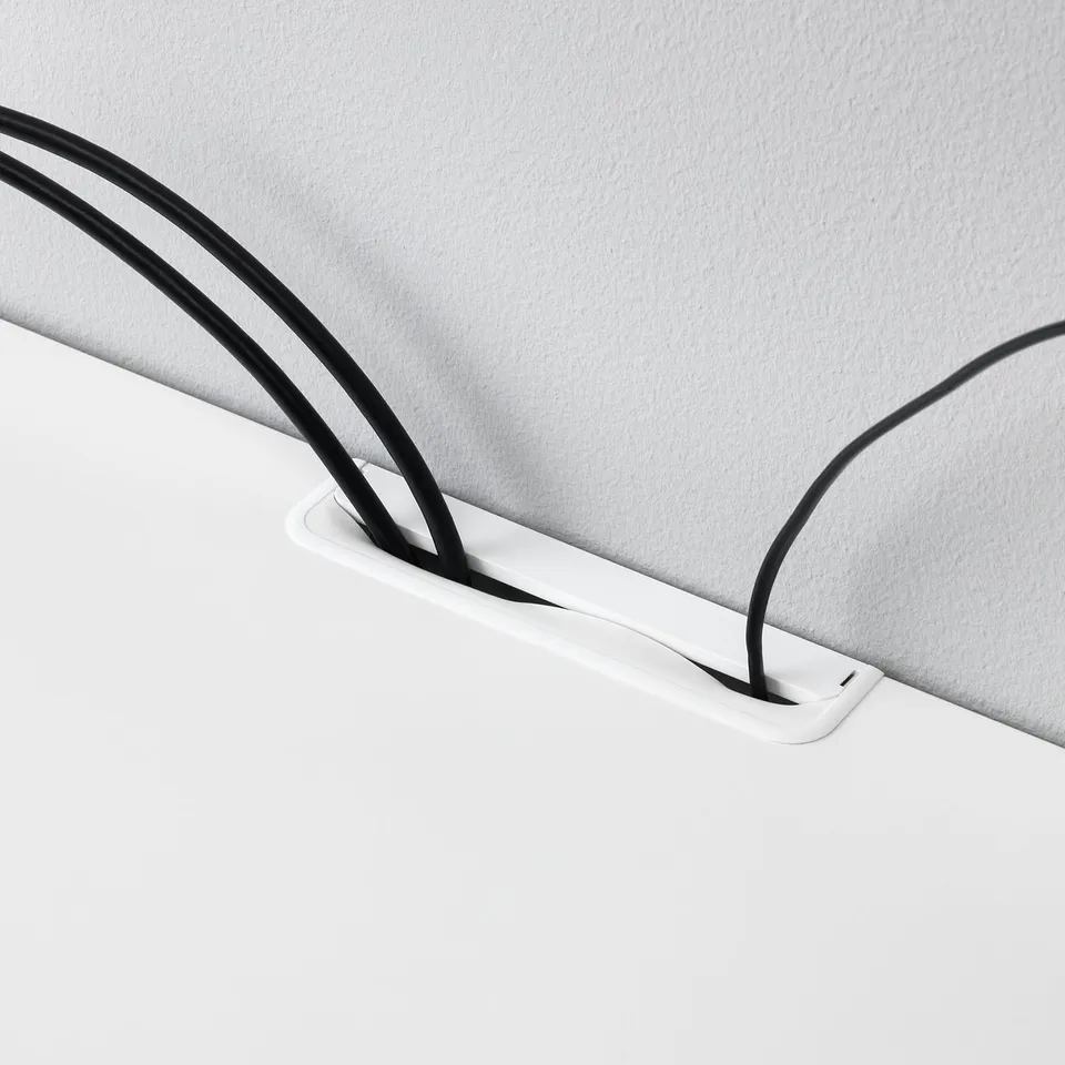 White tv bench with cable management, organised black cords.