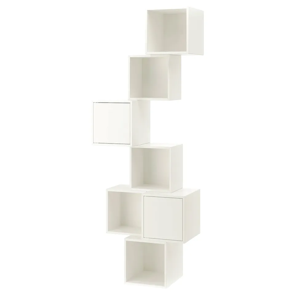 An EKET modular white bookshelf. It a unique, staggered cube design for storage.
