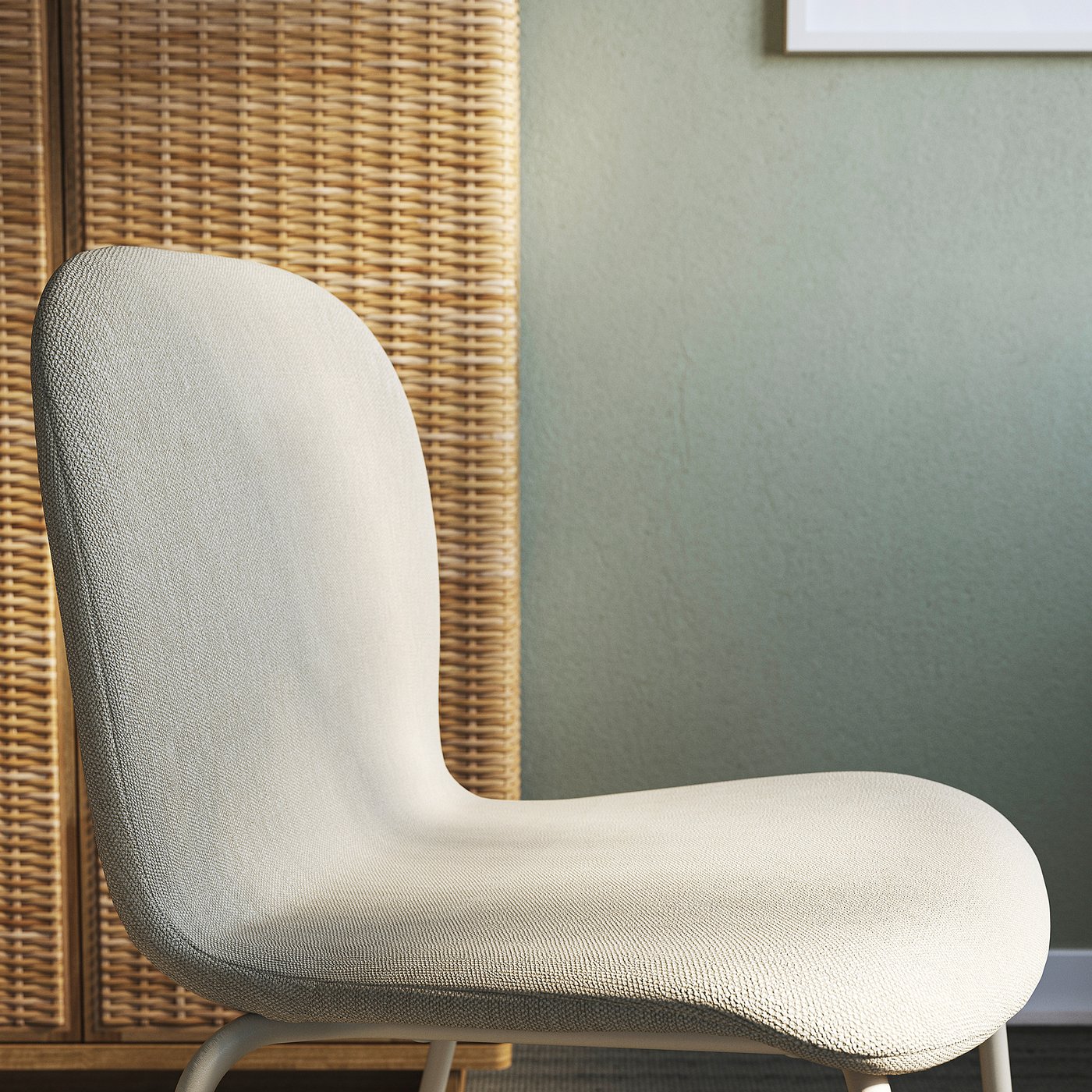 Modern upholstered chair with high back, sleek design, and light colour, set against woven panel wall.