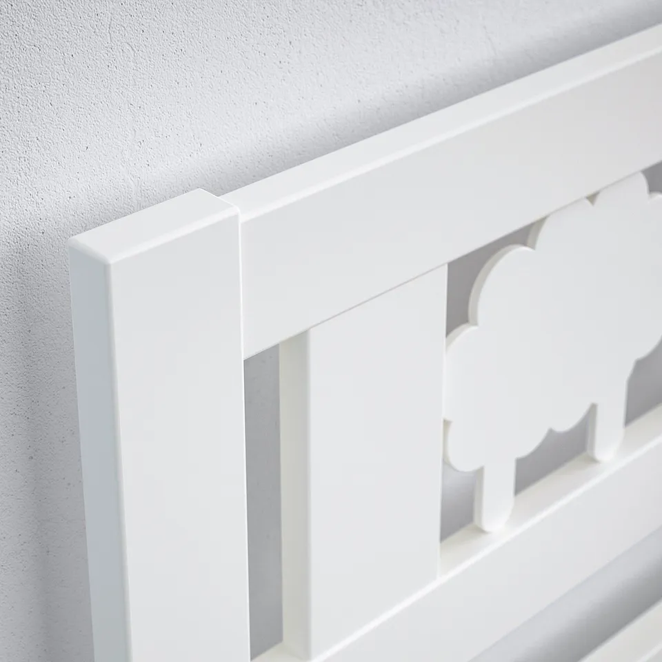 White bed frame corner detail, sleek design, good quality finish.