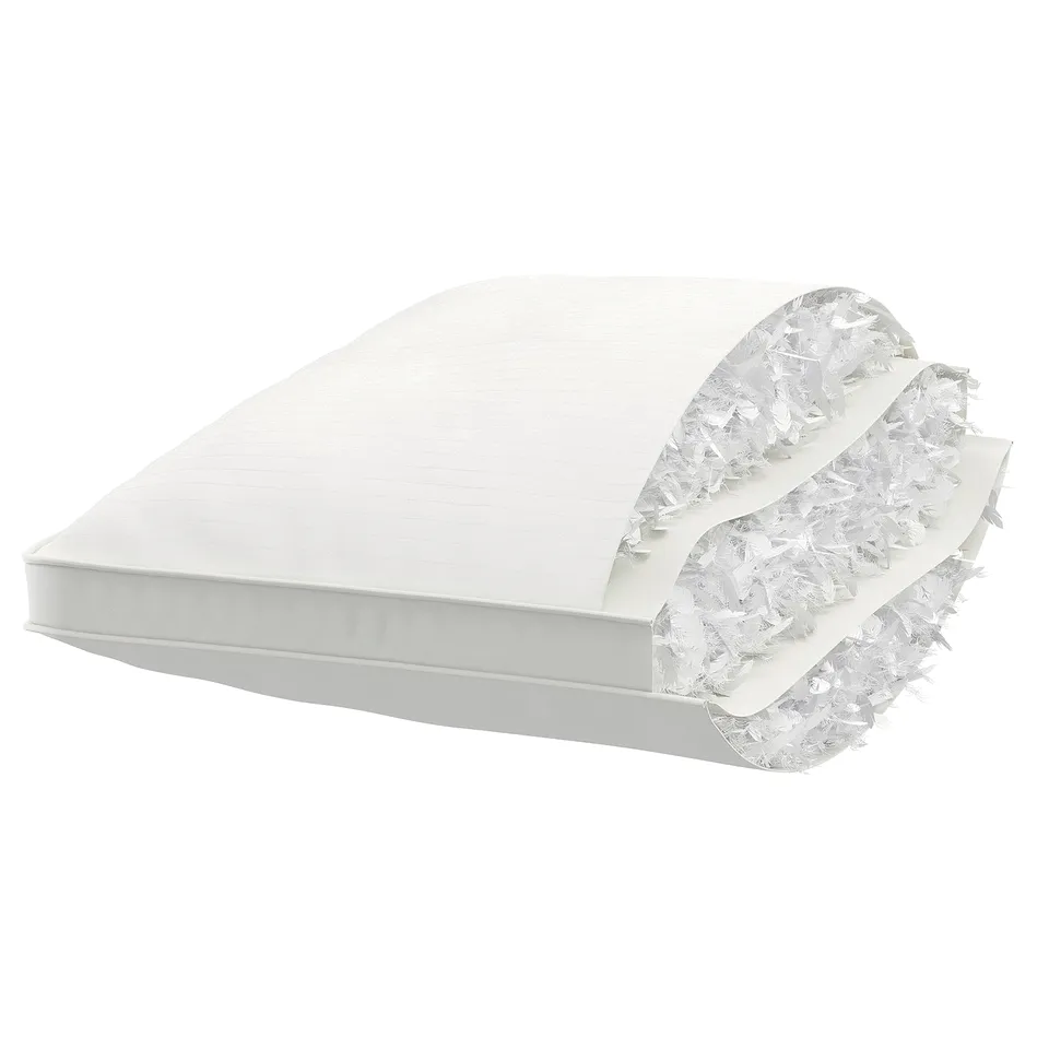 White cushion with recycled cotton cover, containing inner layers of recycled feathers and down.