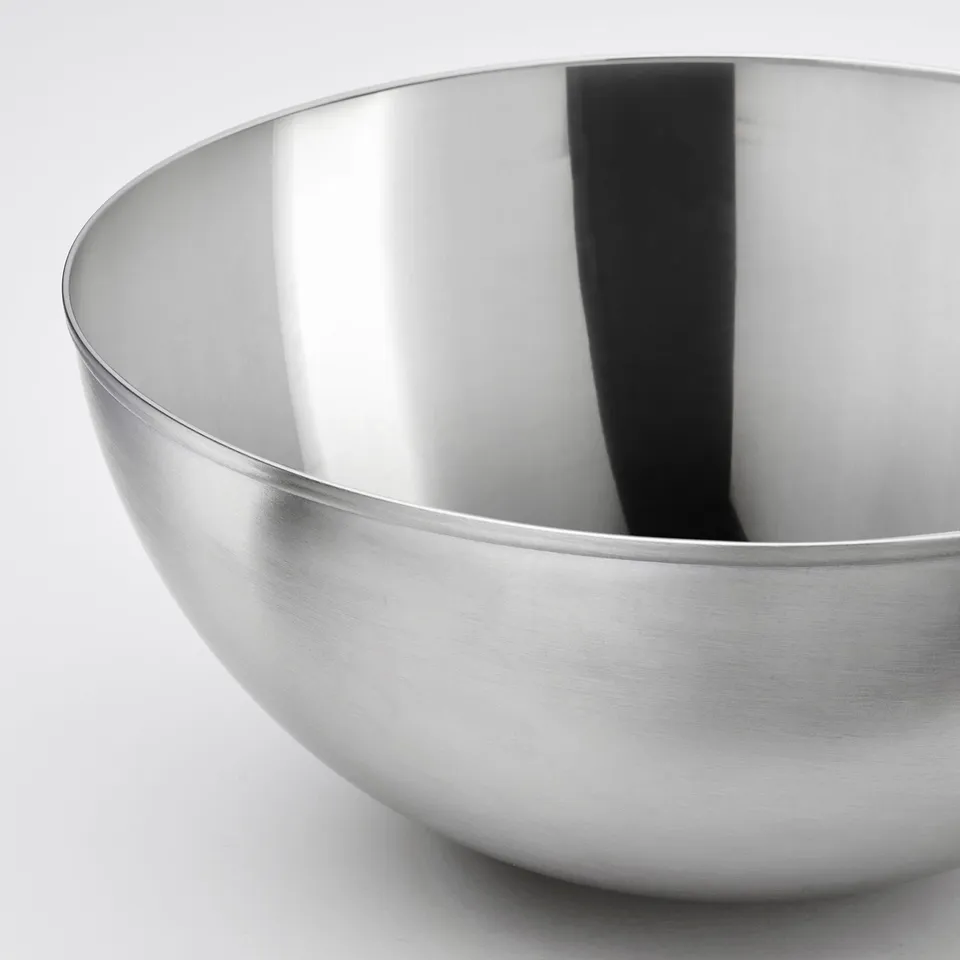 Stainless steel bowl, sleek and polished, reflects light, durable and easy to clean.