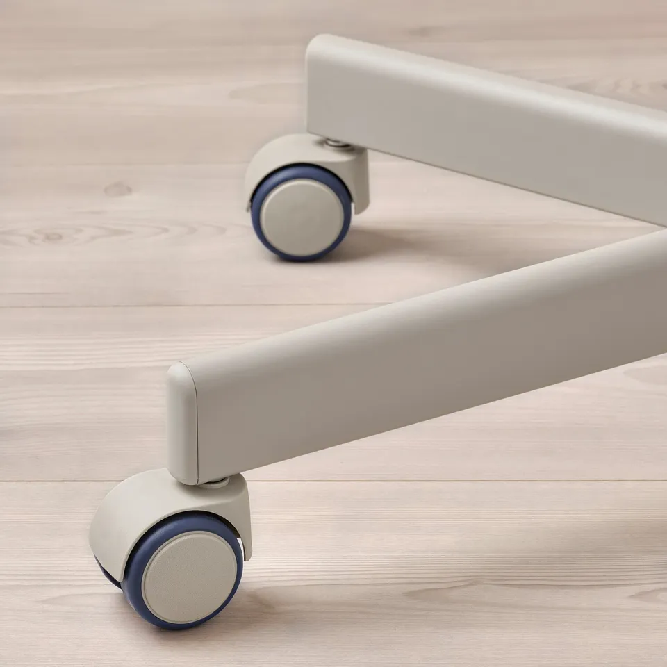 Close-up of modern office chairs wheels on light wood floor. Grey frame, blue wheels.