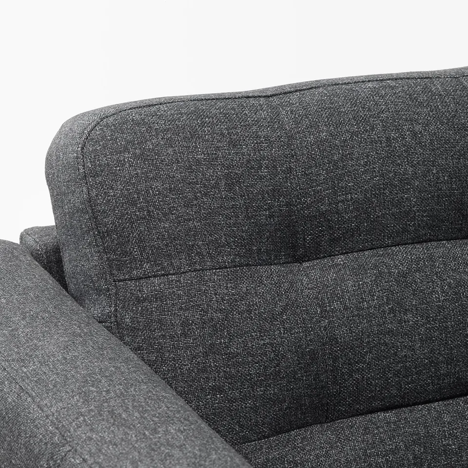 Dark grey sofa with plush cushions, showcasing quality upholstery and neat, stylish design.