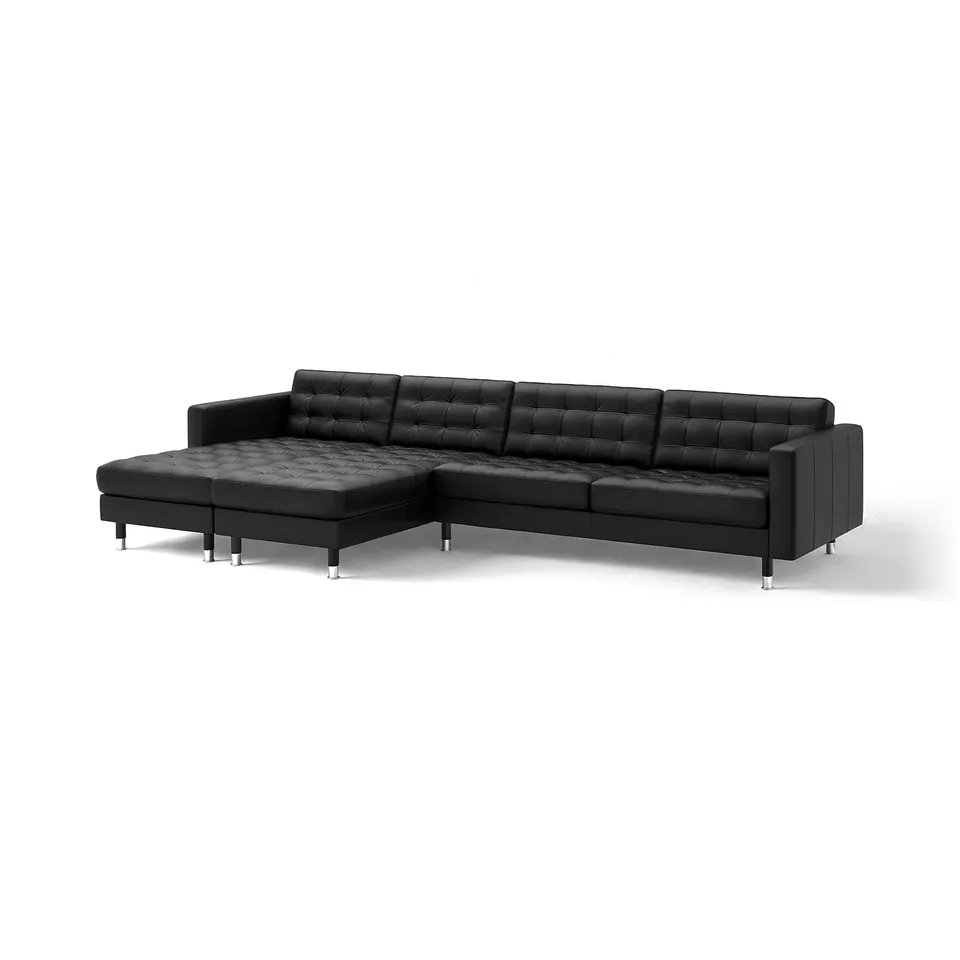 Black l-shaped leather sofa. Modern, tufted design. Sturdy chrome legs. 10-year guarantee.