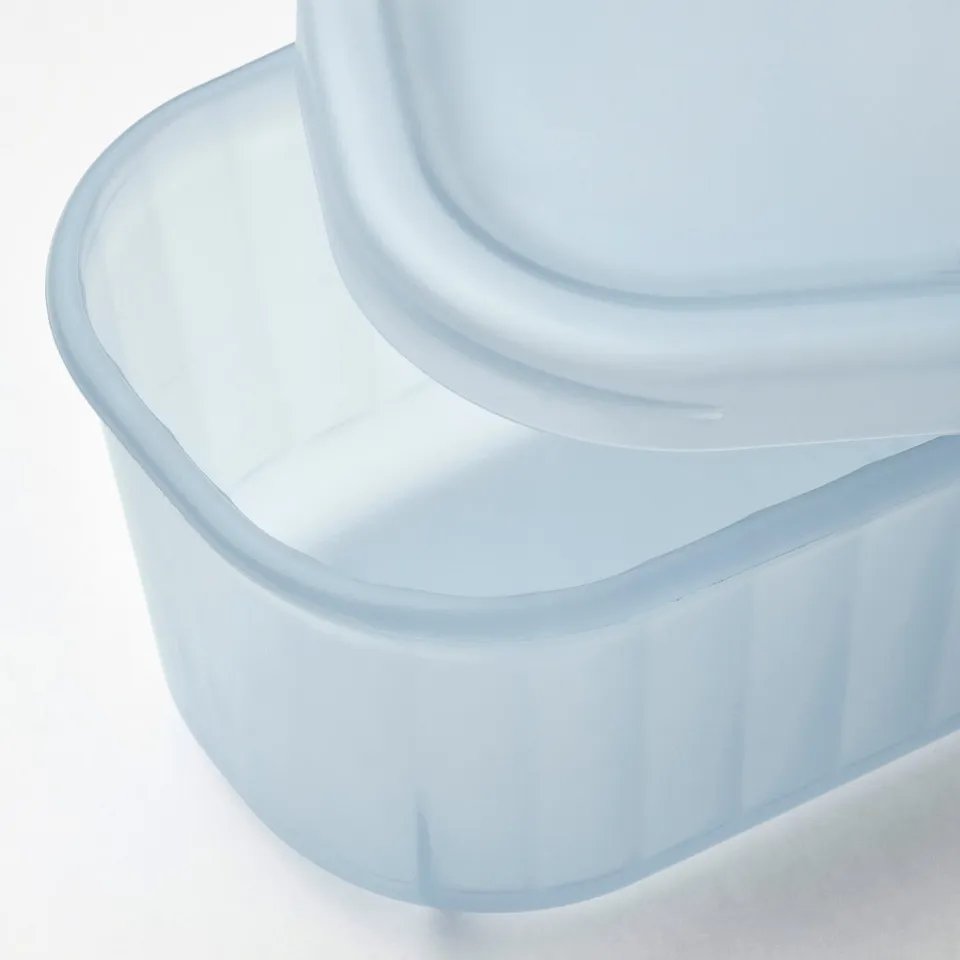 Transparent blue plastic box with lid, partially frosted, showing quality and design.