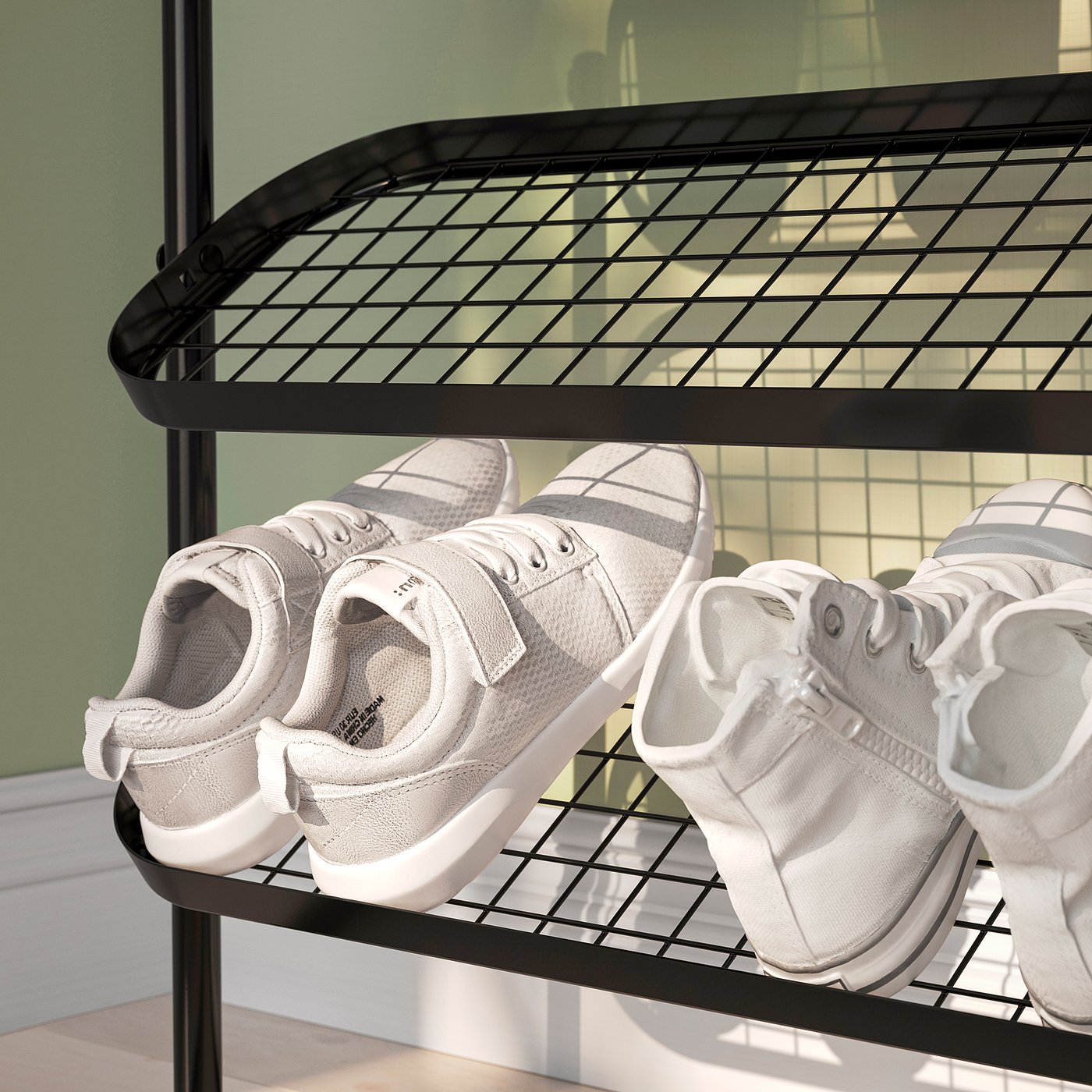 Shoe rack with mesh shelves holding 4 white trainers. Organises and displays footwear efficiently.