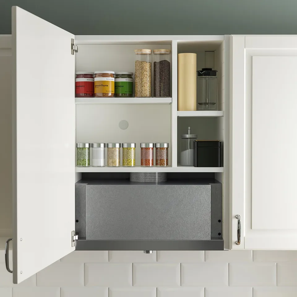 Kitchen cabinet with built-in extractor, spice jars, and items.