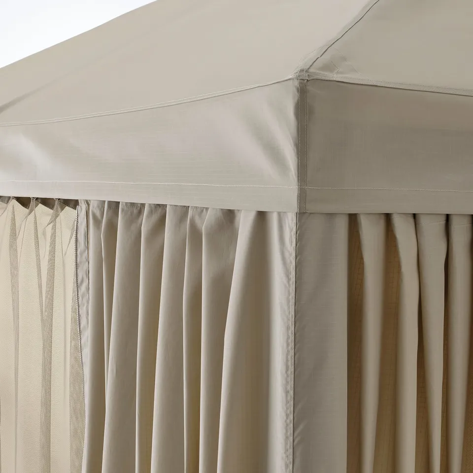 Beige gazebo curtain with recycled polyester, detailing stitching and gathered design, attached to durable, fabric-topped structure.