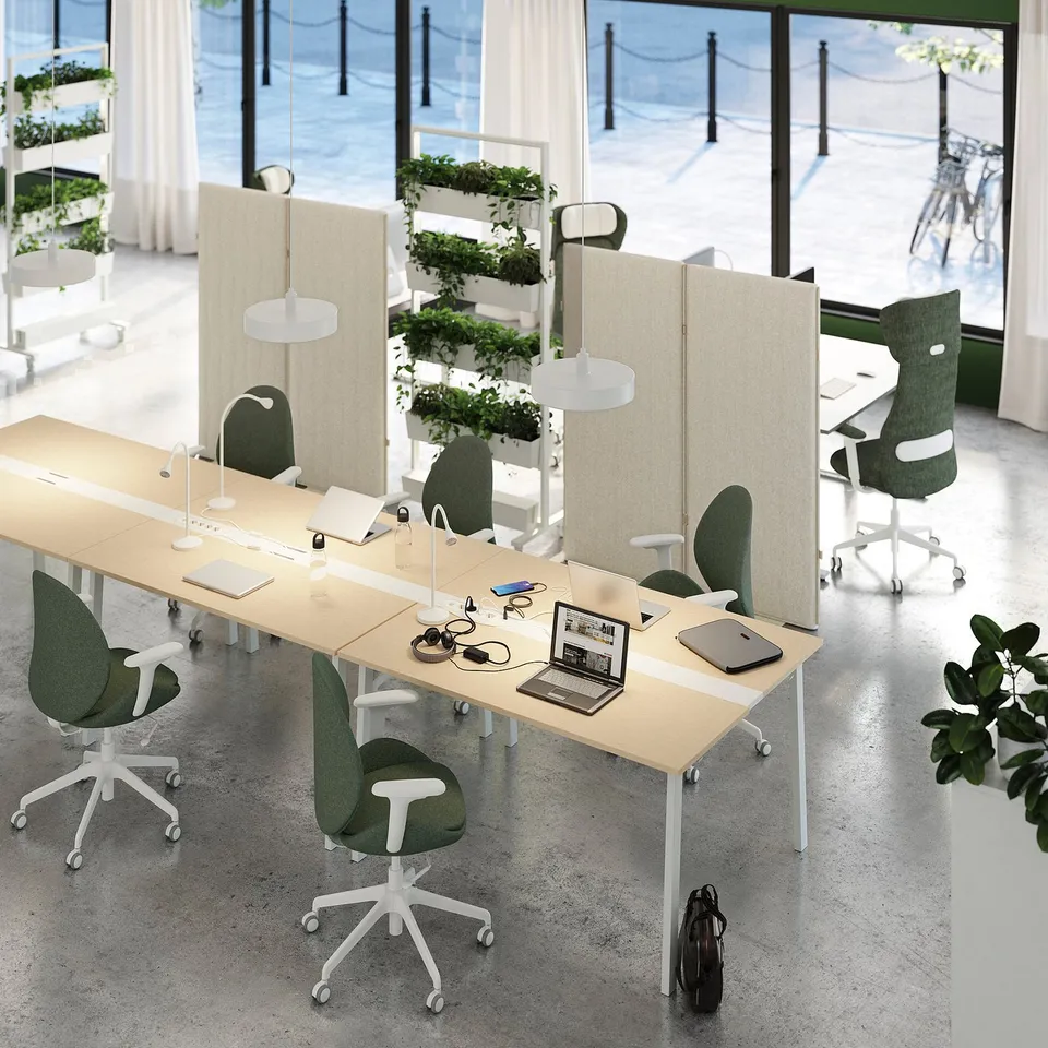 Modern workspace with MITTZON acoustic screens, nature design, green chairs, large window.