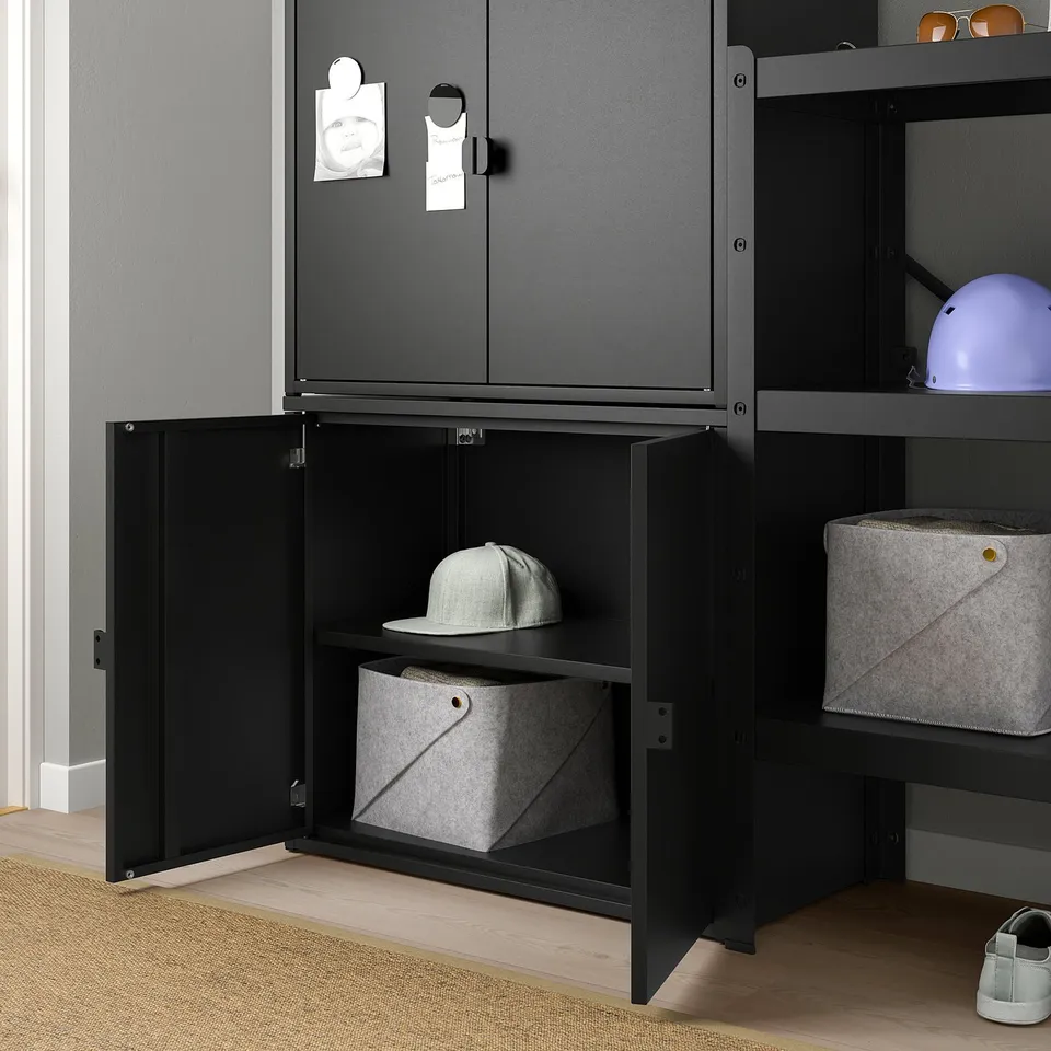Black storage cabinet with open door revealing hat and felt bin. Perfect for heavy items.