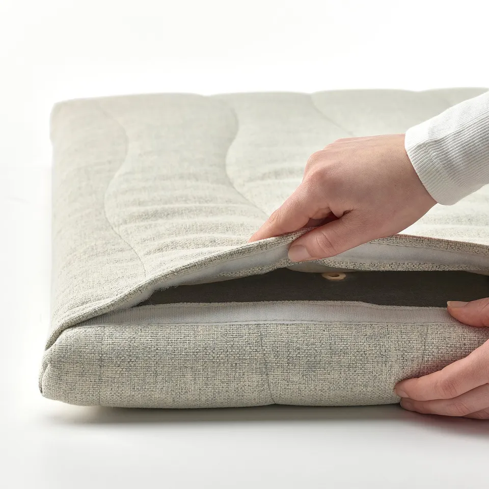 Person attaching acoustic screen to desk. Screen has removable, washable cover. Designed for MITTZON desk.
