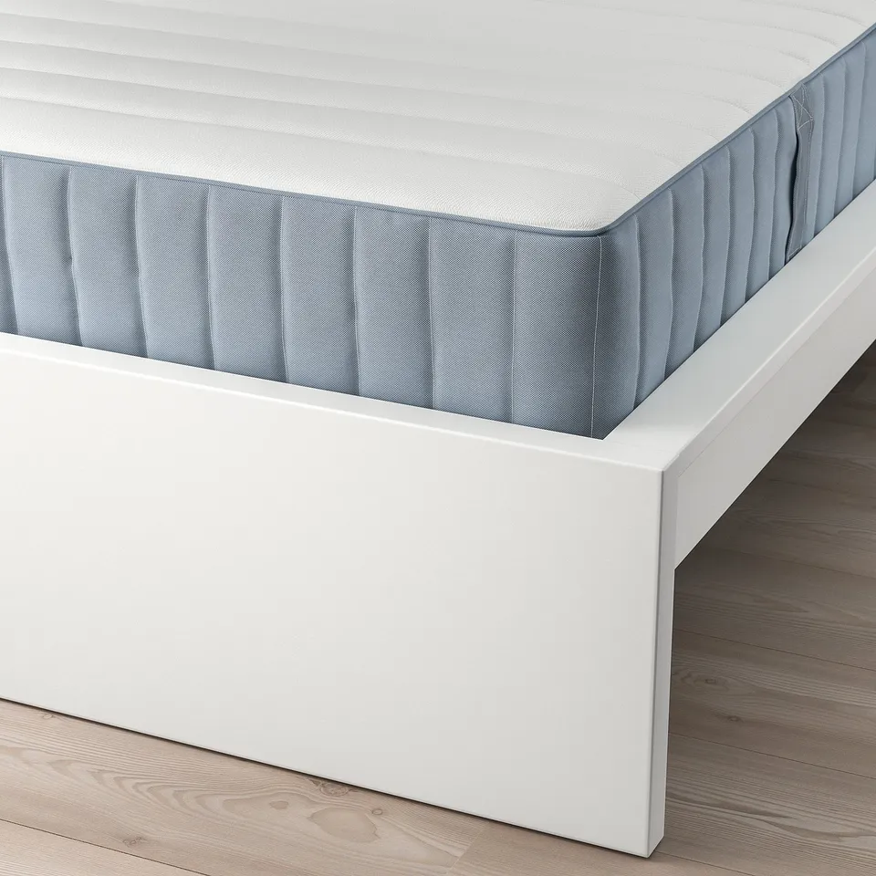 A white MALM bed frame with adjustable slats seen from above, displaying a supportive and clean design.