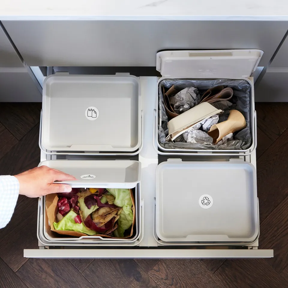 Kitchen with 4 HÅLLBAR waste sorting bins: organic, recycling, and one lid marked.