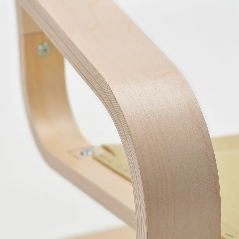 Curved wood furniture detail; smooth, light finish; visible bolts.