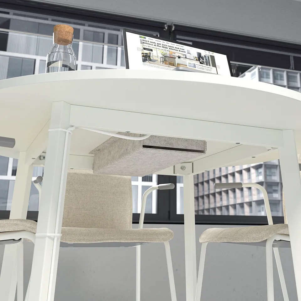 Small round conference table with chairs, perfect for small group meetings. Cable management felt tray included.