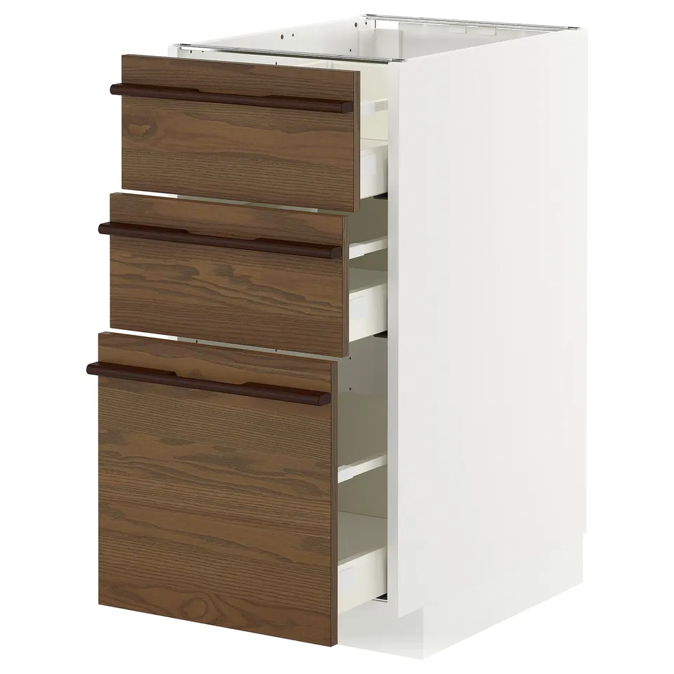 A white METOD kitchen cabinet with dark brown ash veneer drawers and wooden handles.