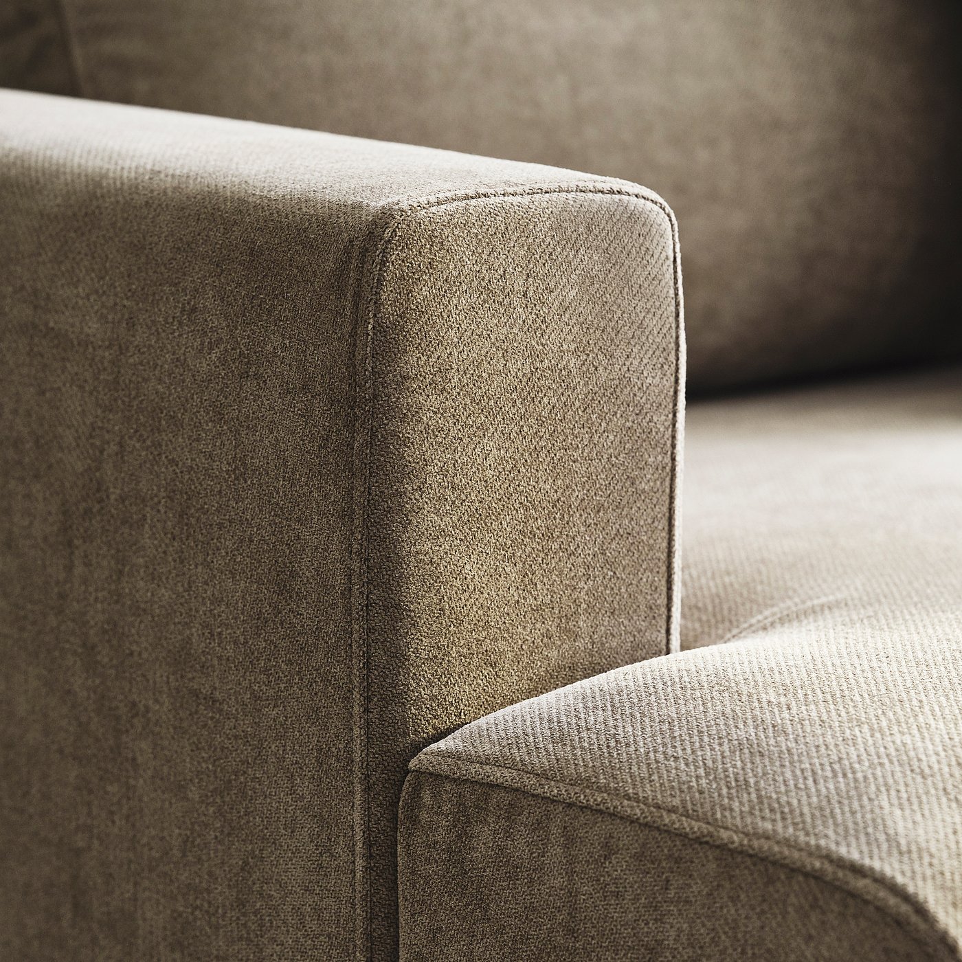 Close-up of plush, upholstered sofa. Soft, textured fabric high-quality design and comfort.