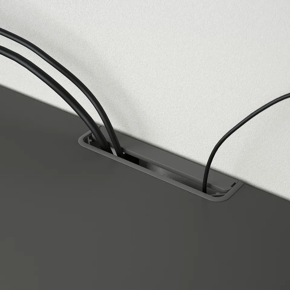 Close-up of BESTÅ tv benchs cable management system, showing sleek slots guiding wires neatly behind the furniture.