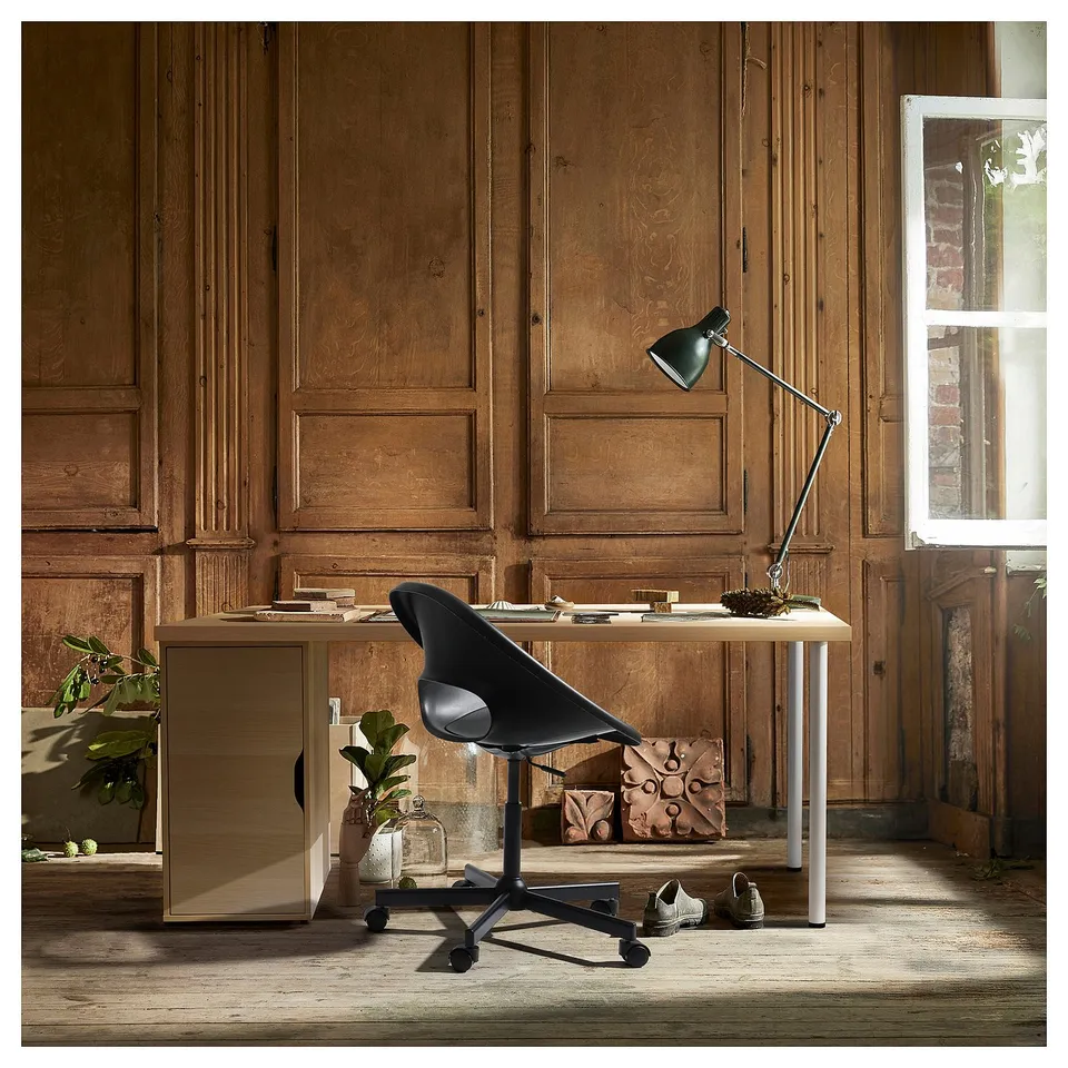 Home office setup: LAGKAPTEN desk, light wood, modern design, black chair, adjustable lamp, wooden panelled room.