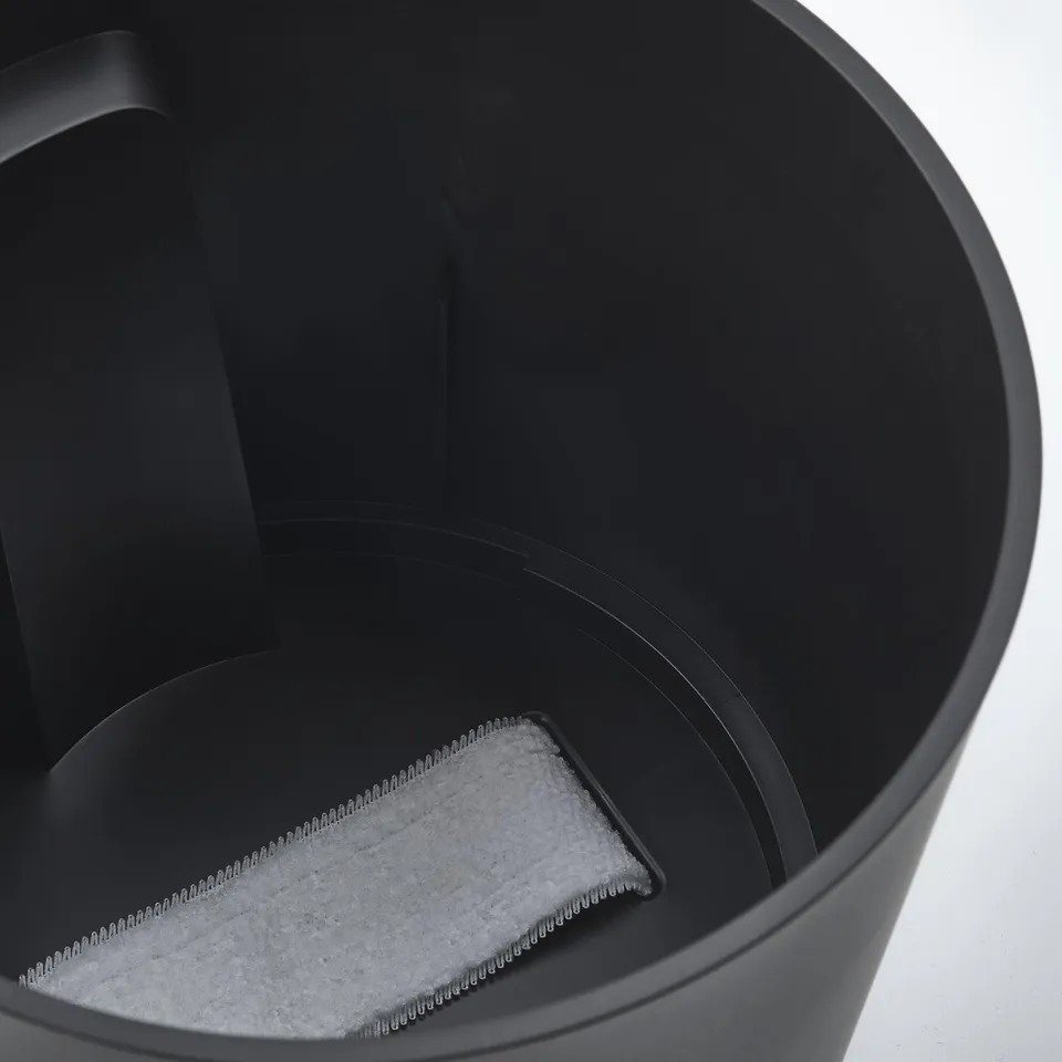 Black self-watering planter with visible water level indicator and grey wick.