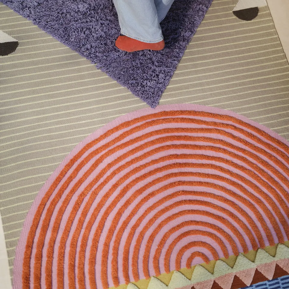 Colourful handwoven rugs with distinct patterns. Striped and geometric shapes.