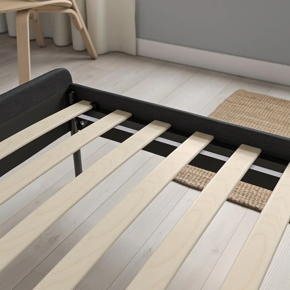 Bed frame with wooden slats for support, soft padding, and a headboard for comfort.
