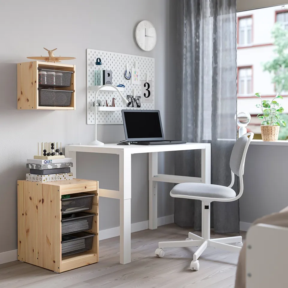 Home office: TROFAST storage, desk, laptop, chair, clock, plants.