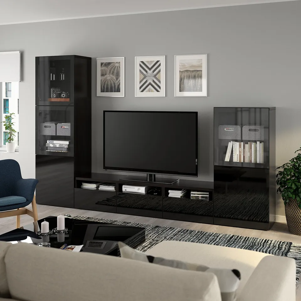 Modern living space with BESTÅ black tv unit and shelves, featuring a flat screen tv, stylish decor, and cosy seating.
