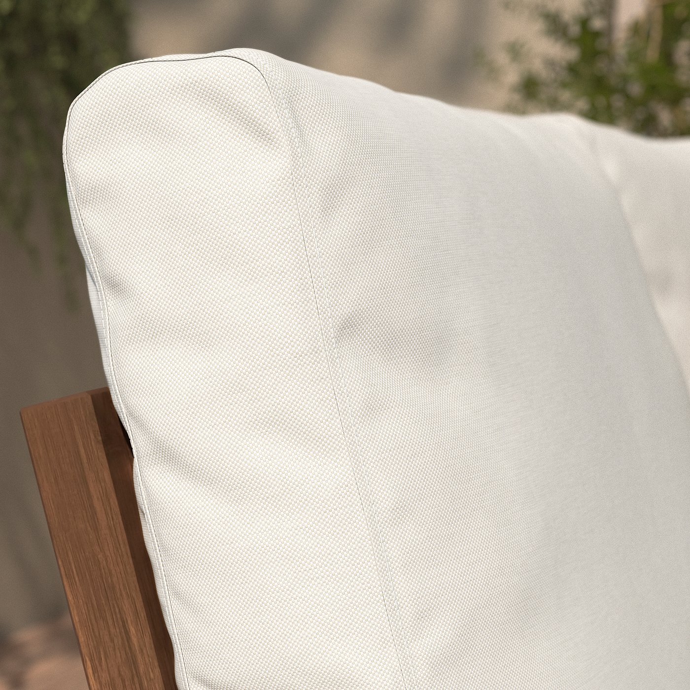 Close-up of NÄMMARÖ chair. White cushion on wooden frame, showcasing sturdy design and comfort.