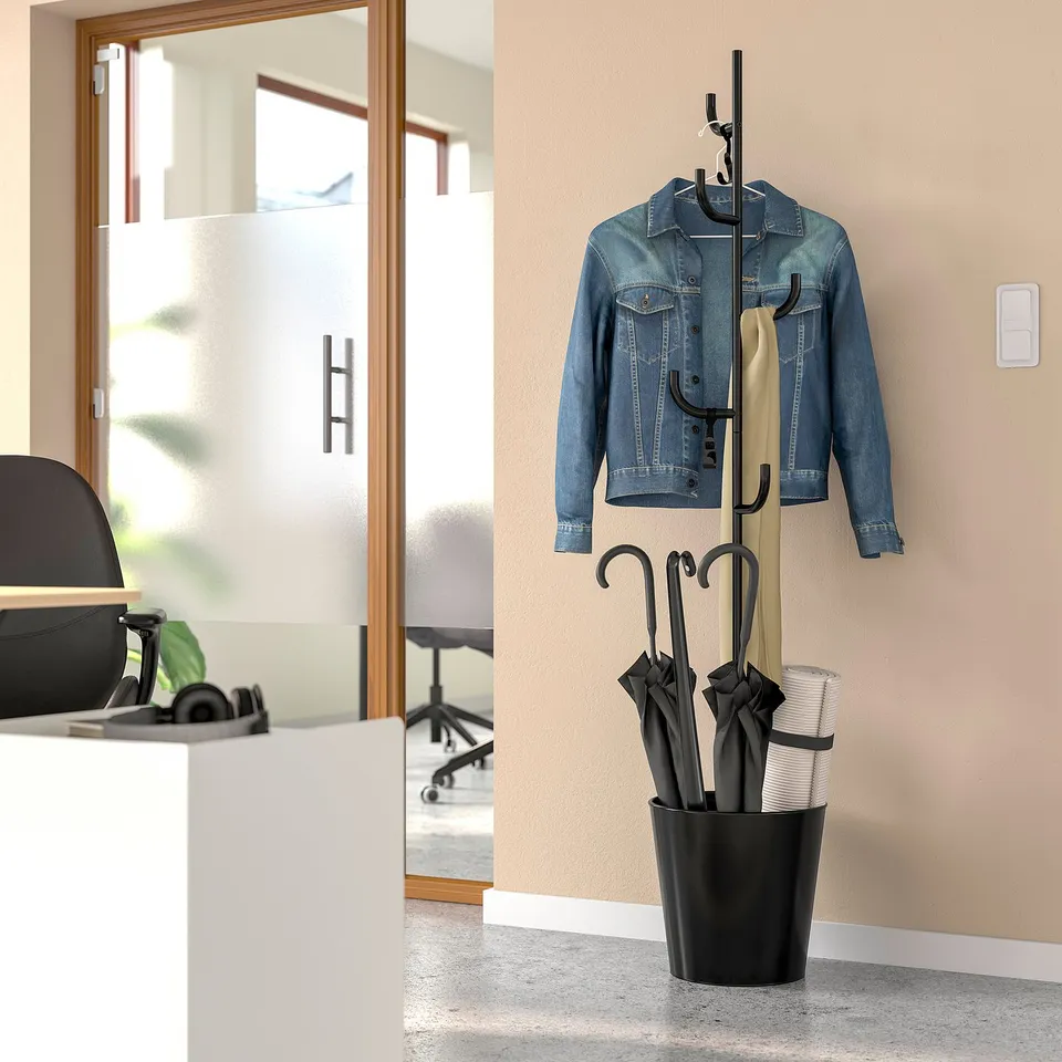 Black ÄLGANÄS coat stand holds denim jacket, beige coat, umbrellas, and yoga mat in compact home entry.