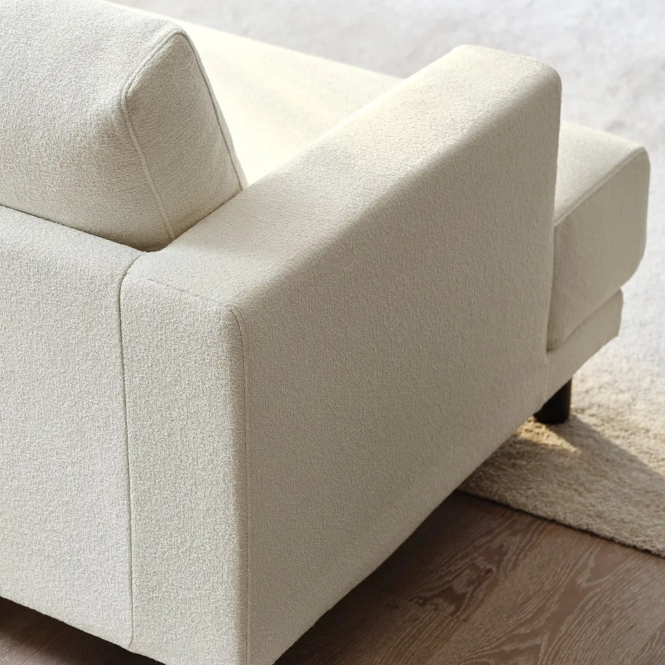 Light beige UPPÅKRA sofa, clean and cosy design, premium fabric texture, complete with supportive cushions and solid wooden legs.
