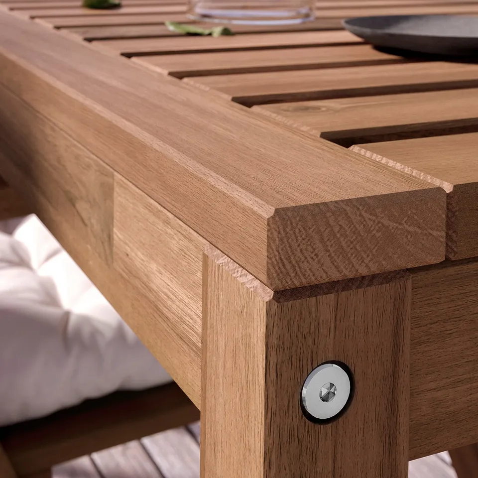 Wooden outdoor table with slatted top and round edge detail.