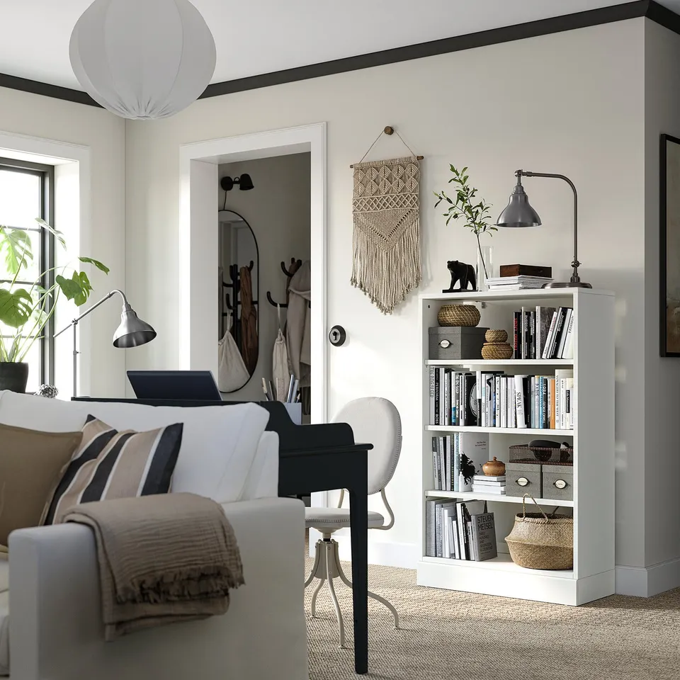 Living room with HAVSTA bookshelf, chair, and decor.