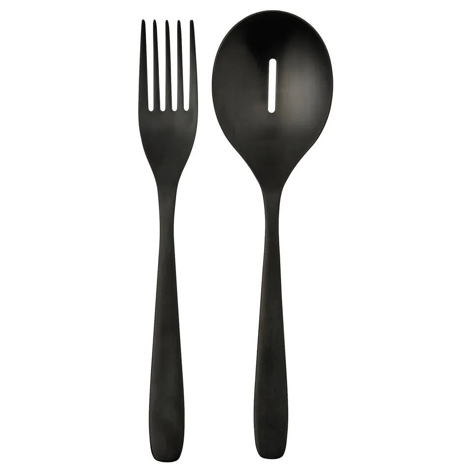 Black TILLAGD cutlery set: sleek matte serving fork and spoon with modern, minimalist design. Stainless steel.