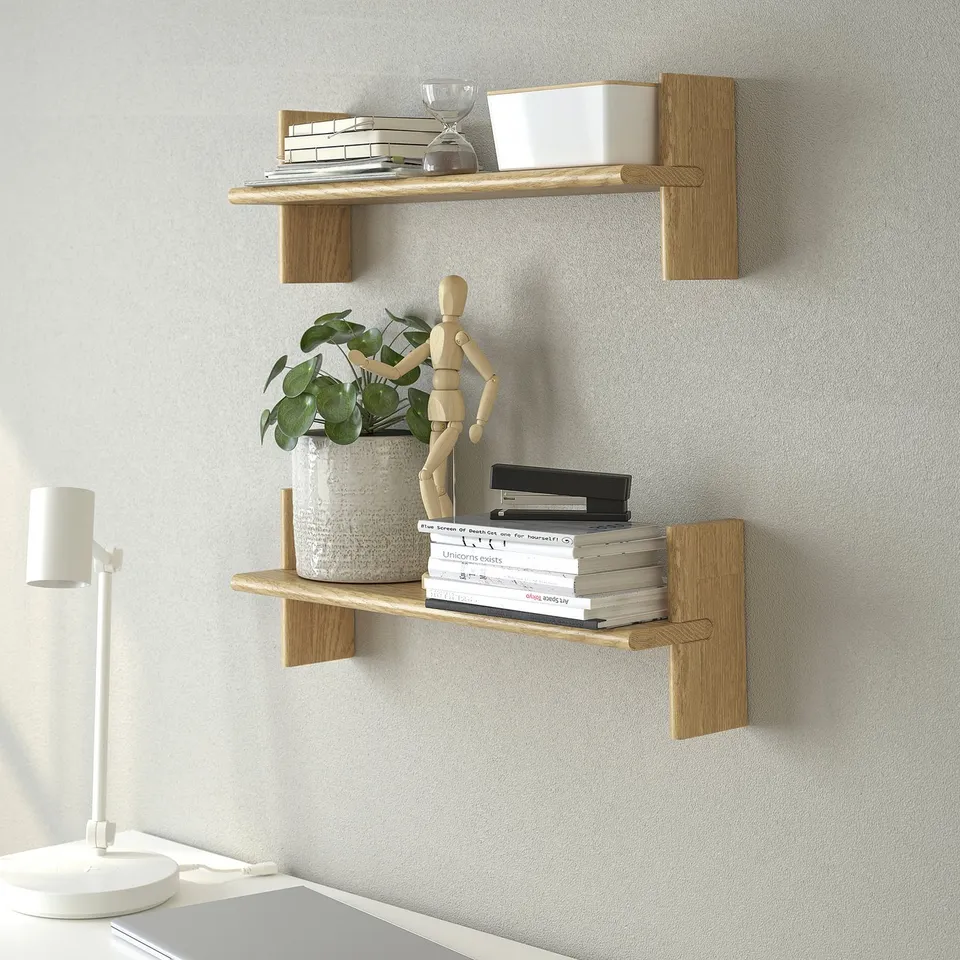 Light wood shelves display books, plant, and art figure. Wall-mounted, home decor.