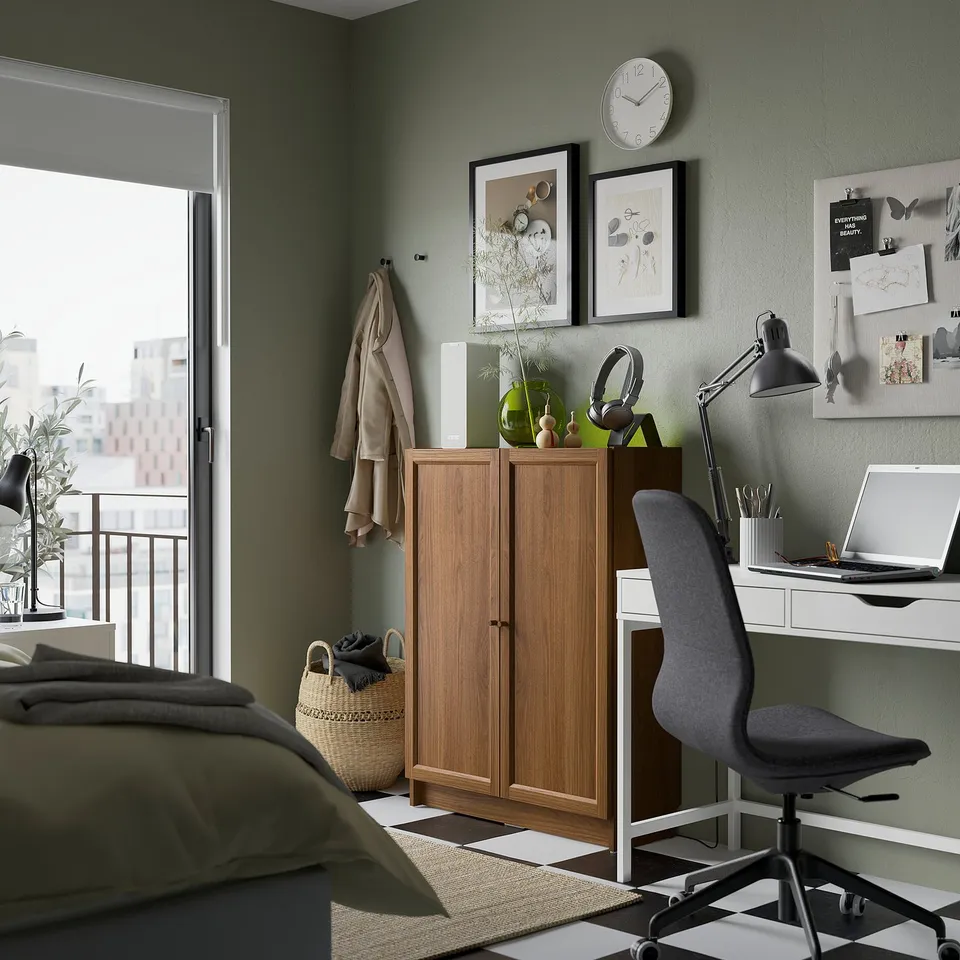 Cosy bedroom with white BILLY bookcase, art, clock, home office, bed & balcony.