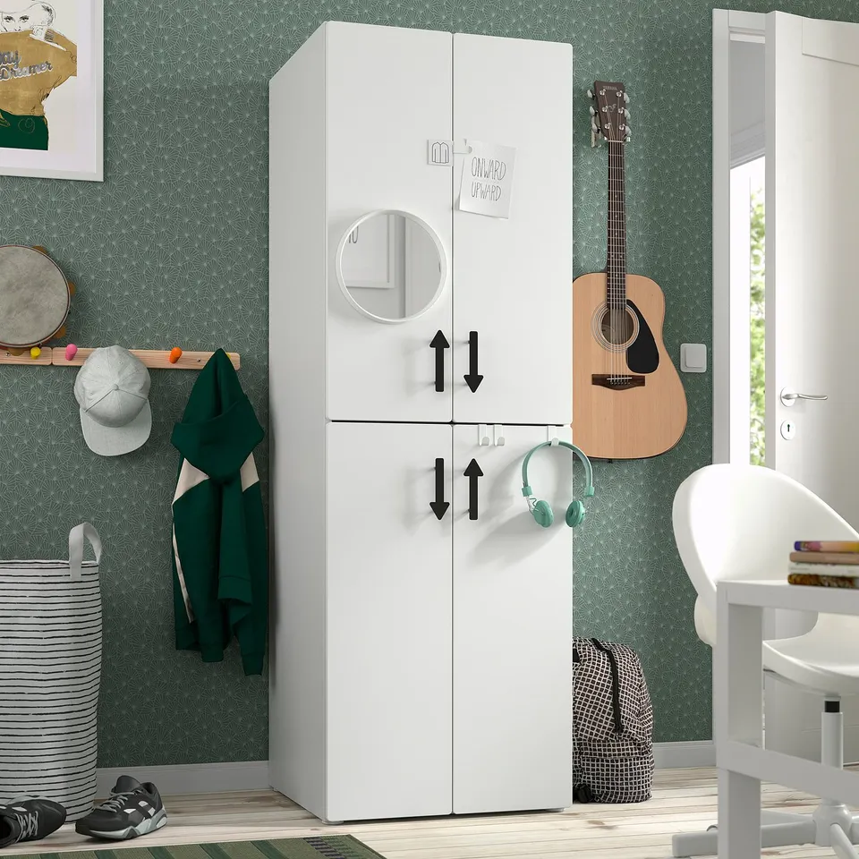 A modern teens room with a white SMÅSTAD wardrobe featuring round mirror and hooks, standing near a guitar and desk.