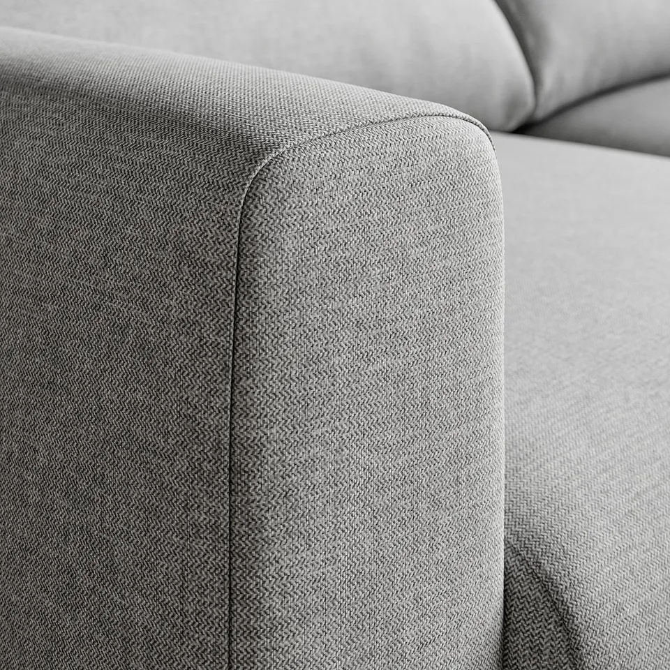 Close-up of a modern sofas plush, grey fabric with clean lines and comfortable cushions.