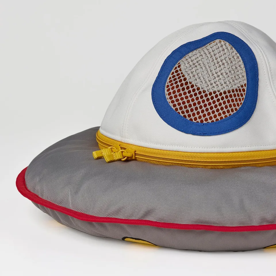 Spaceship toy, made of soft recycled materials, with a mesh patch and sturdy zip, designed for children.