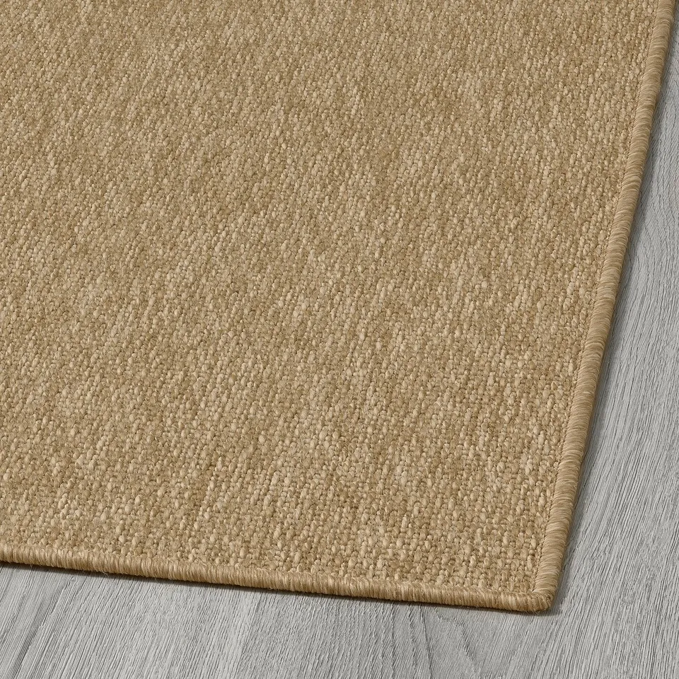 Flatwoven rug, beige-brown tones, smooth texture. Ideal indoor/outdoor use, easy to clean.
