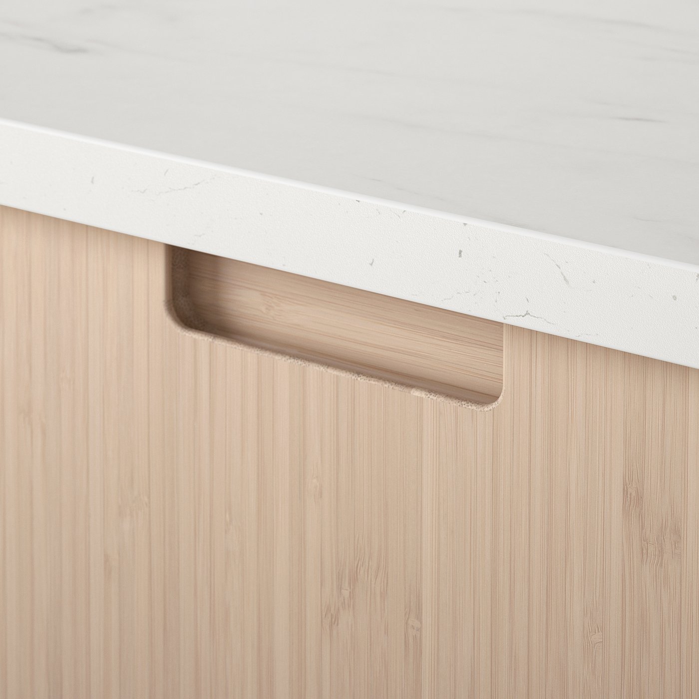 Modern kitchen detail: smooth white countertop meets natural bamboo drawer with sleek handle.