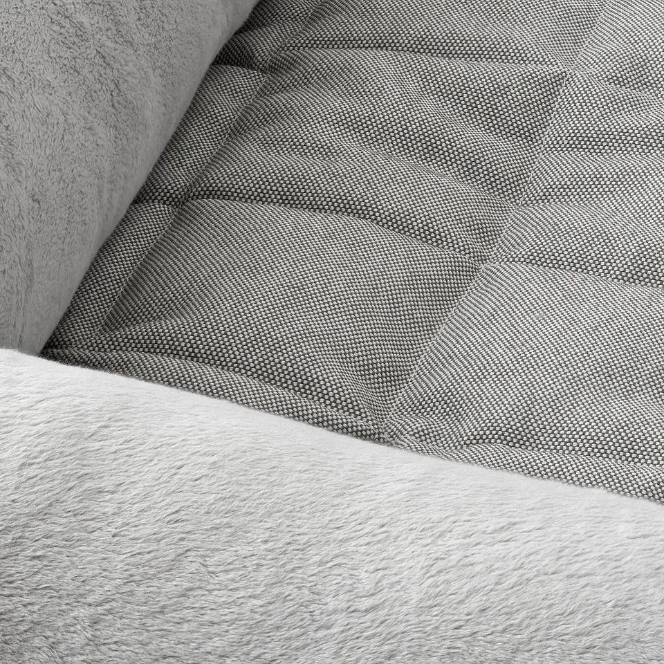 A corner of a dog bed with soft, plush fabric and a patterned inner lining, highlighting its comfort and quality.