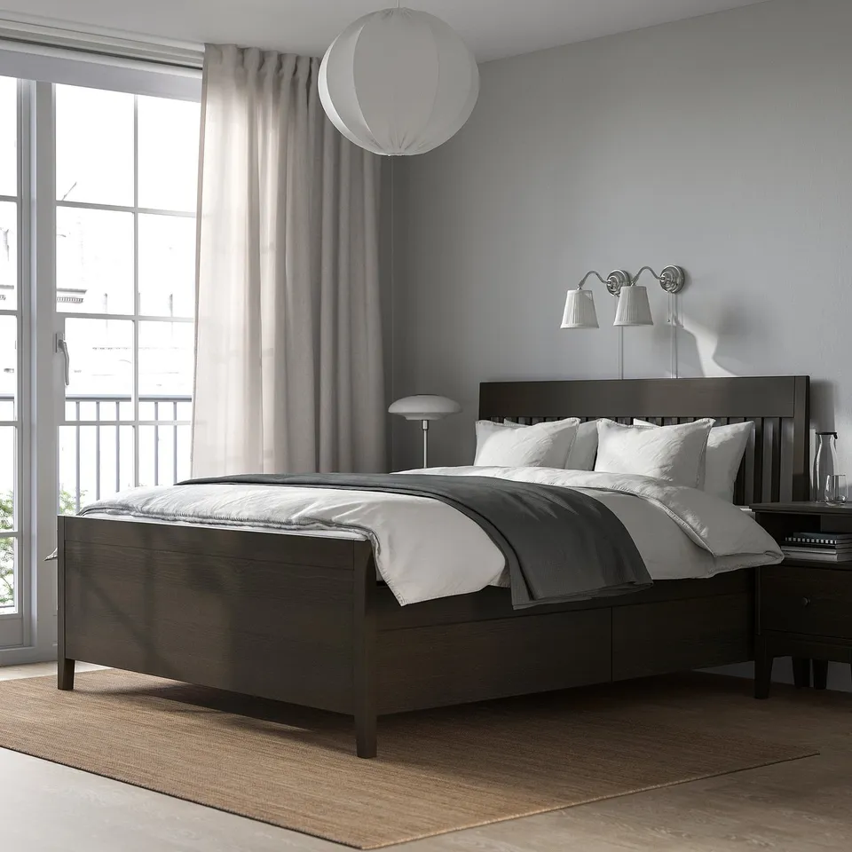 Bedroom: IDANÄS dark wood bed, grey bedding, white lamps, large window, plush rug.