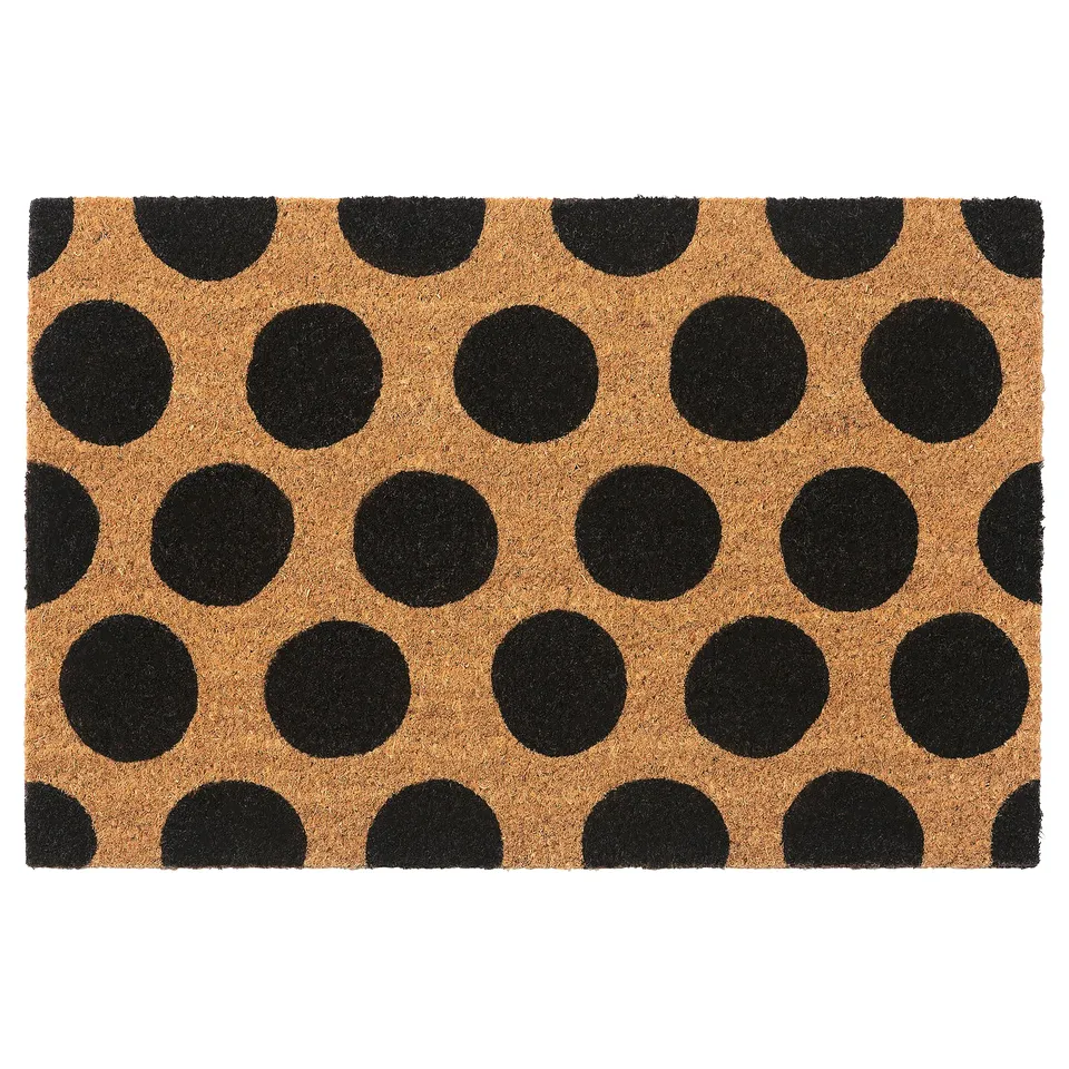 A TÅGFORDON door mat with black dots on beige background, made of coir and jute.